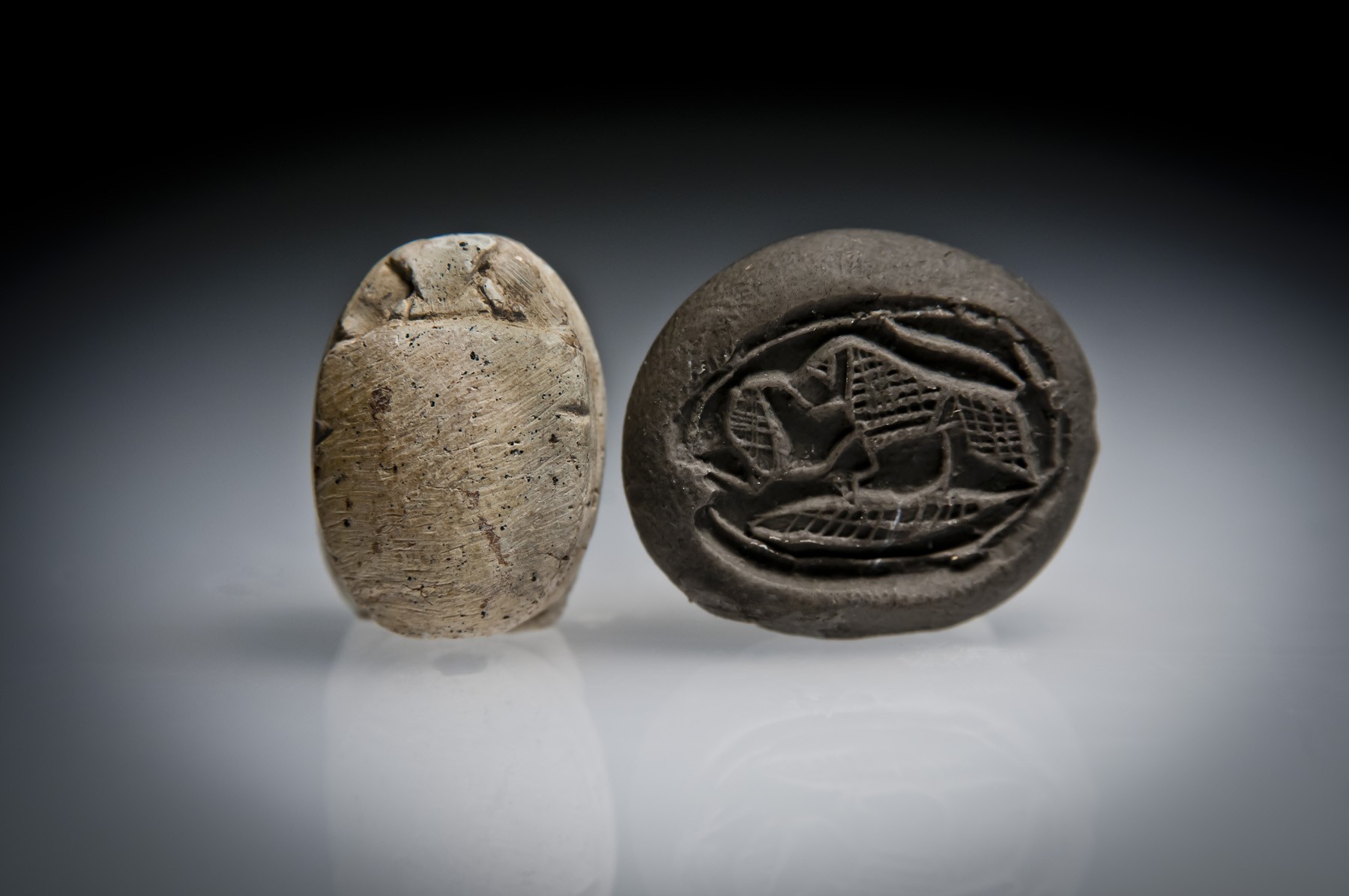 A Hyksos Steatite Scarab Engraved with a Lion Confronting a Cobra